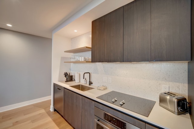 kitchen featuring light hardwood / wood-style flooring, tasteful backsplash, stainless steel appliances, sink, and dark brown cabinetry