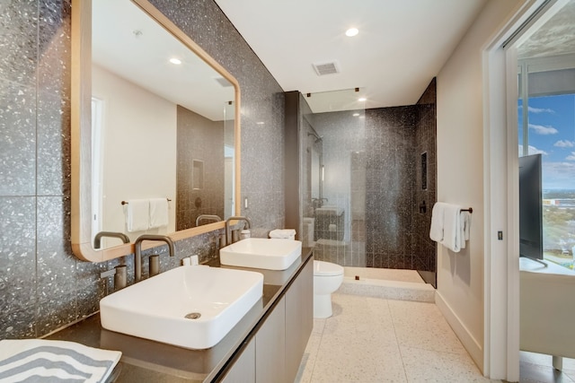 bathroom with tile patterned floors, vanity, walk in shower, and toilet