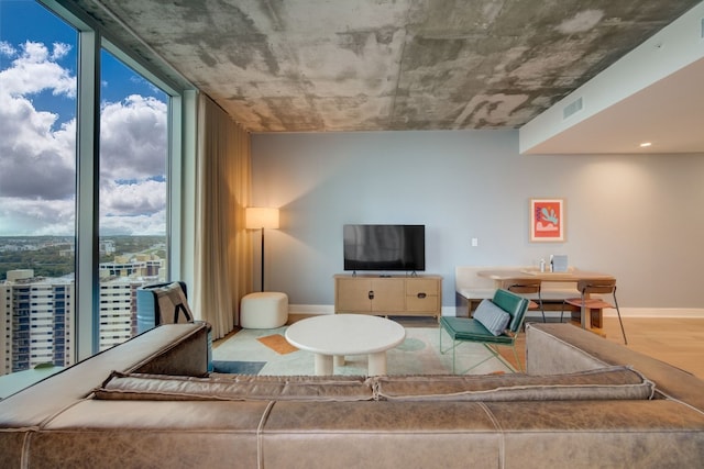 living room featuring wood-type flooring and expansive windows