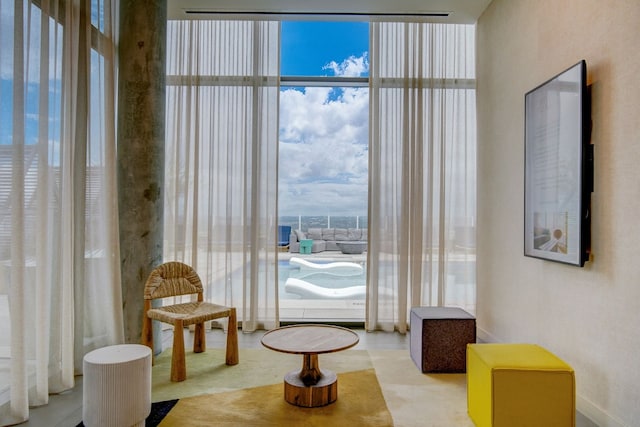 living area with floor to ceiling windows