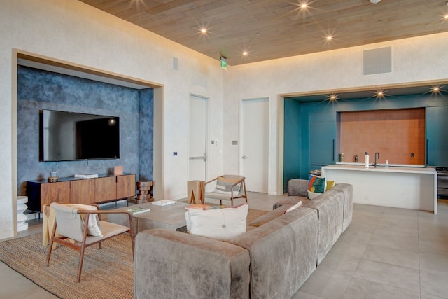 living room featuring wood ceiling and light tile patterned floors