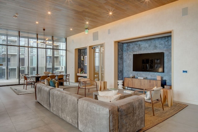 living room featuring an inviting chandelier, wooden ceiling, and light tile patterned floors