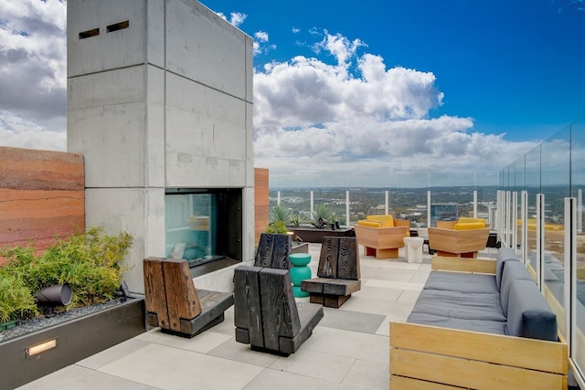 view of patio with an outdoor living space with a fireplace