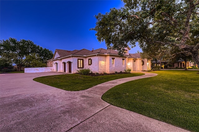 mediterranean / spanish house featuring a lawn