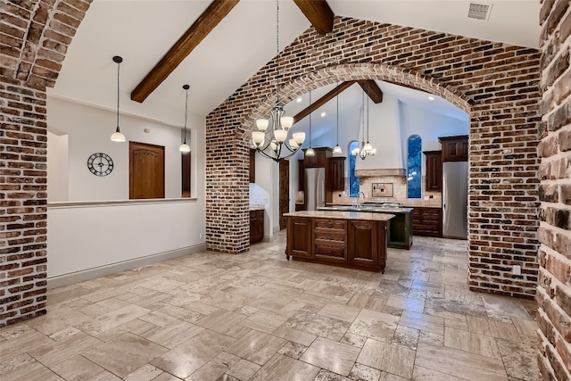 kitchen featuring beamed ceiling, high vaulted ceiling, and a center island