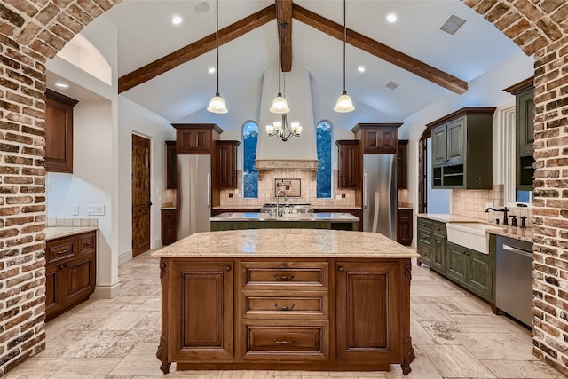 kitchen featuring pendant lighting, beamed ceiling, a center island, tasteful backsplash, and stainless steel appliances