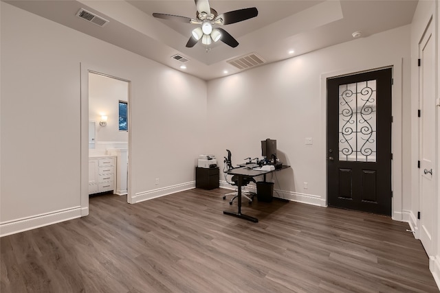 office with ceiling fan and dark wood-type flooring