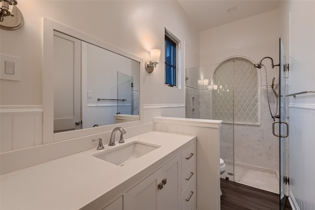 bathroom featuring vanity, hardwood / wood-style flooring, an enclosed shower, and toilet