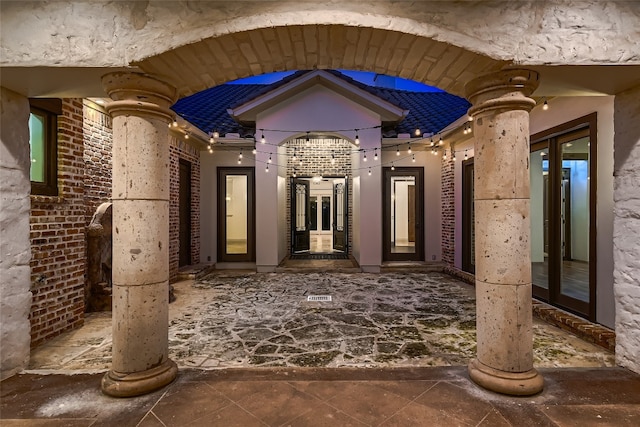 exterior space featuring decorative columns