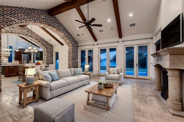 living room with brick wall, beamed ceiling, french doors, and high vaulted ceiling