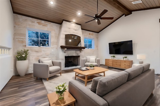 living room with wood ceiling, beam ceiling, a large fireplace, ceiling fan, and hardwood / wood-style floors