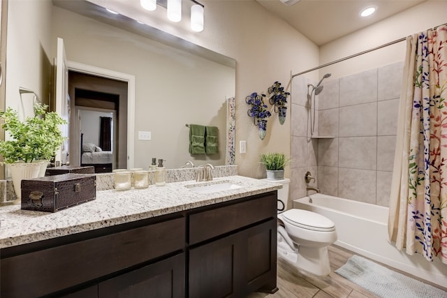 full bathroom featuring vanity, shower / bath combo, and toilet