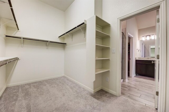 spacious closet with light colored carpet