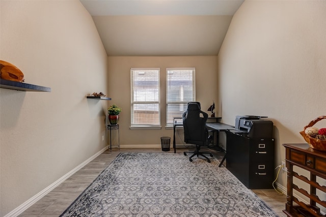 office area with hardwood / wood-style floors and vaulted ceiling