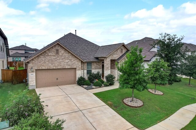 view of front of property with a front yard and a garage