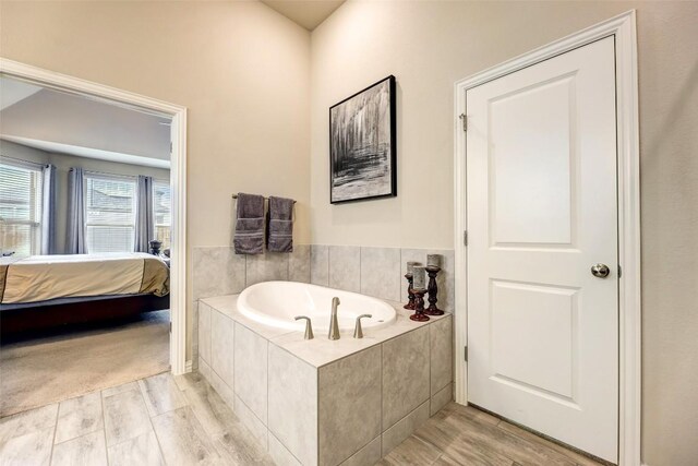 bathroom featuring tiled tub