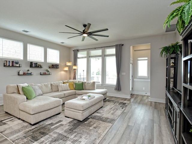 living room featuring ceiling fan and hardwood / wood-style flooring