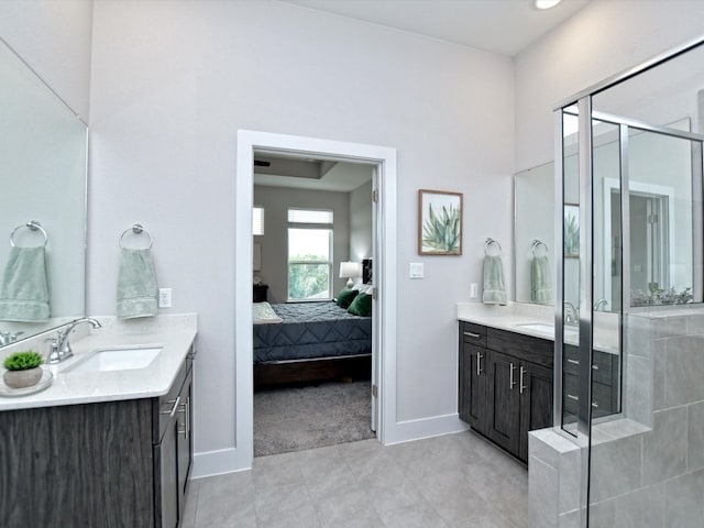 bathroom featuring a shower with shower door, tile flooring, and vanity