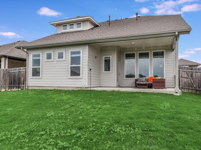 rear view of house with a yard and a patio