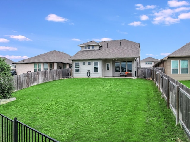 rear view of house with a yard