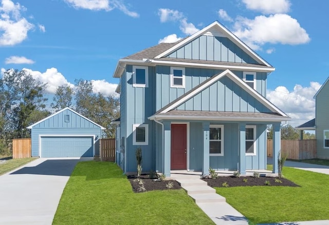 view of front of property featuring an outbuilding, a front lawn, a porch, and a garage