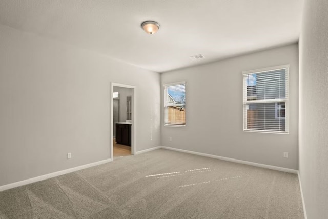 empty room featuring light carpet