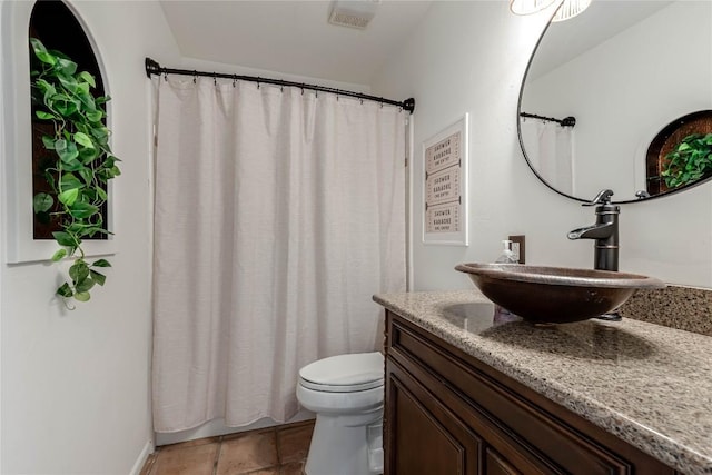 bathroom with toilet, tile patterned flooring, visible vents, and vanity