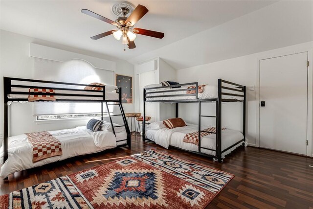 bedroom with ceiling fan and dark wood-type flooring