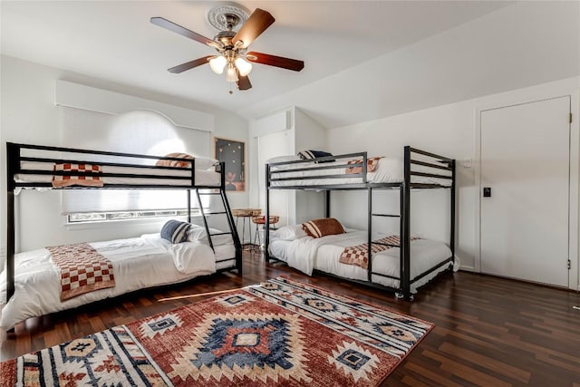 bedroom featuring lofted ceiling, dark wood-style flooring, and ceiling fan