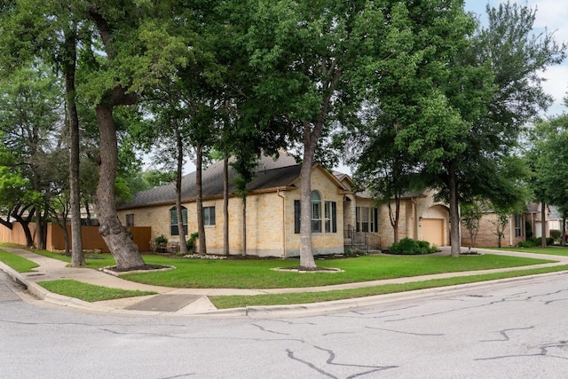 view of front of home with a front yard and a garage