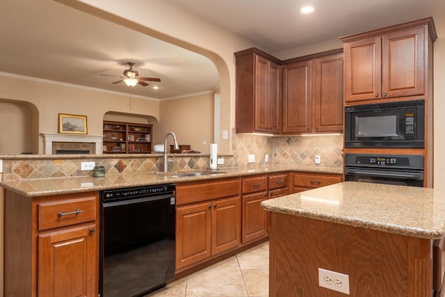 kitchen with decorative backsplash, kitchen peninsula, ceiling fan, sink, and black appliances