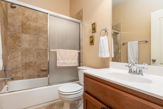 full bathroom with shower / bath combination with glass door, vanity, toilet, and tile patterned flooring