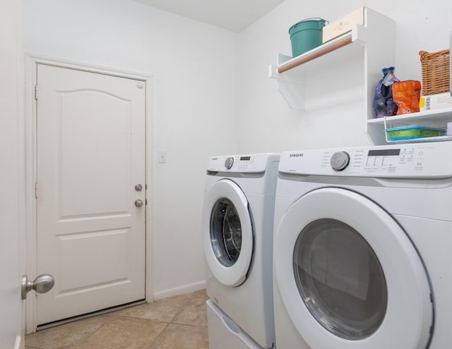 clothes washing area with light tile patterned flooring and independent washer and dryer