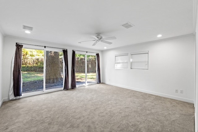 spare room featuring ceiling fan, ornamental molding, and light carpet