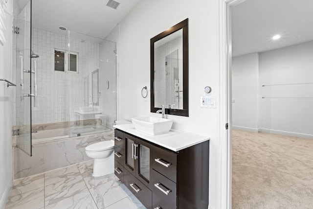 full bathroom with vanity, tiled shower / bath combo, and toilet