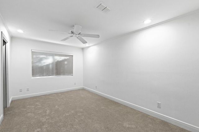 carpeted spare room with ceiling fan