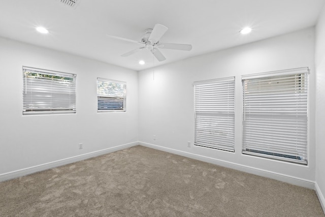 spare room with carpet and ceiling fan