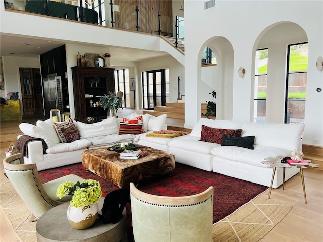 living room featuring hardwood / wood-style floors and a high ceiling