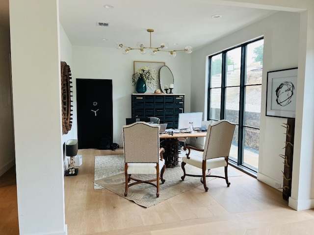 dining room with a chandelier and light wood-type flooring