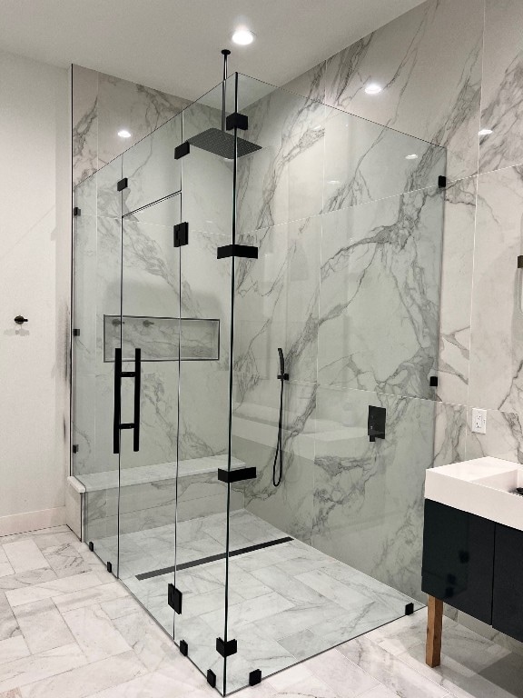 bathroom featuring walk in shower and tile walls