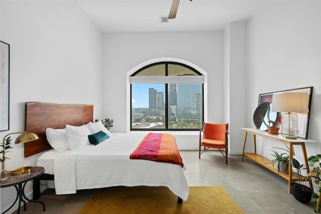 bedroom with ceiling fan and concrete floors