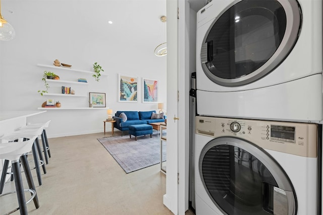 laundry room with stacked washer / dryer