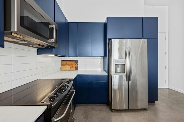 kitchen featuring tasteful backsplash, blue cabinets, and appliances with stainless steel finishes