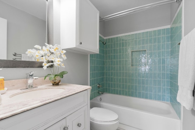 full bathroom with tiled shower / bath combo, vanity, and toilet