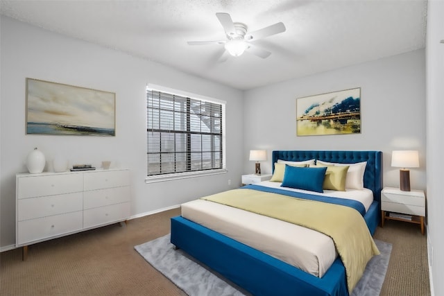 bedroom featuring ceiling fan and dark carpet