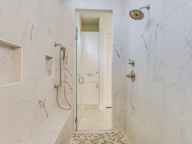 bathroom with a tile shower