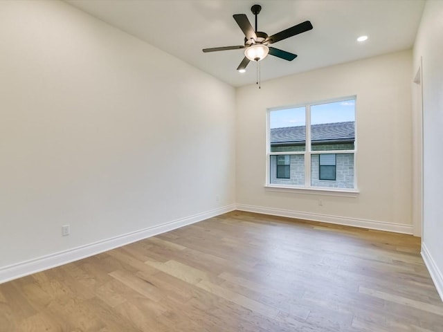 spare room featuring ceiling fan and light wood-type flooring