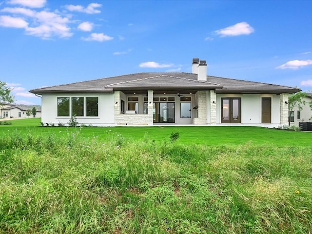 rear view of property with a yard