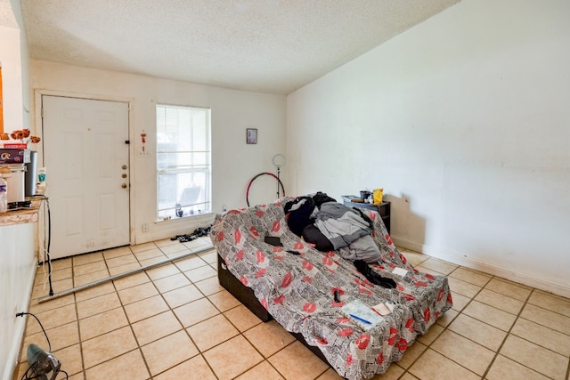 tiled bedroom with a textured ceiling