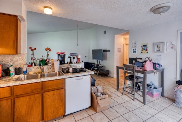 kitchen with a textured ceiling, sink, white dishwasher, and light tile floors